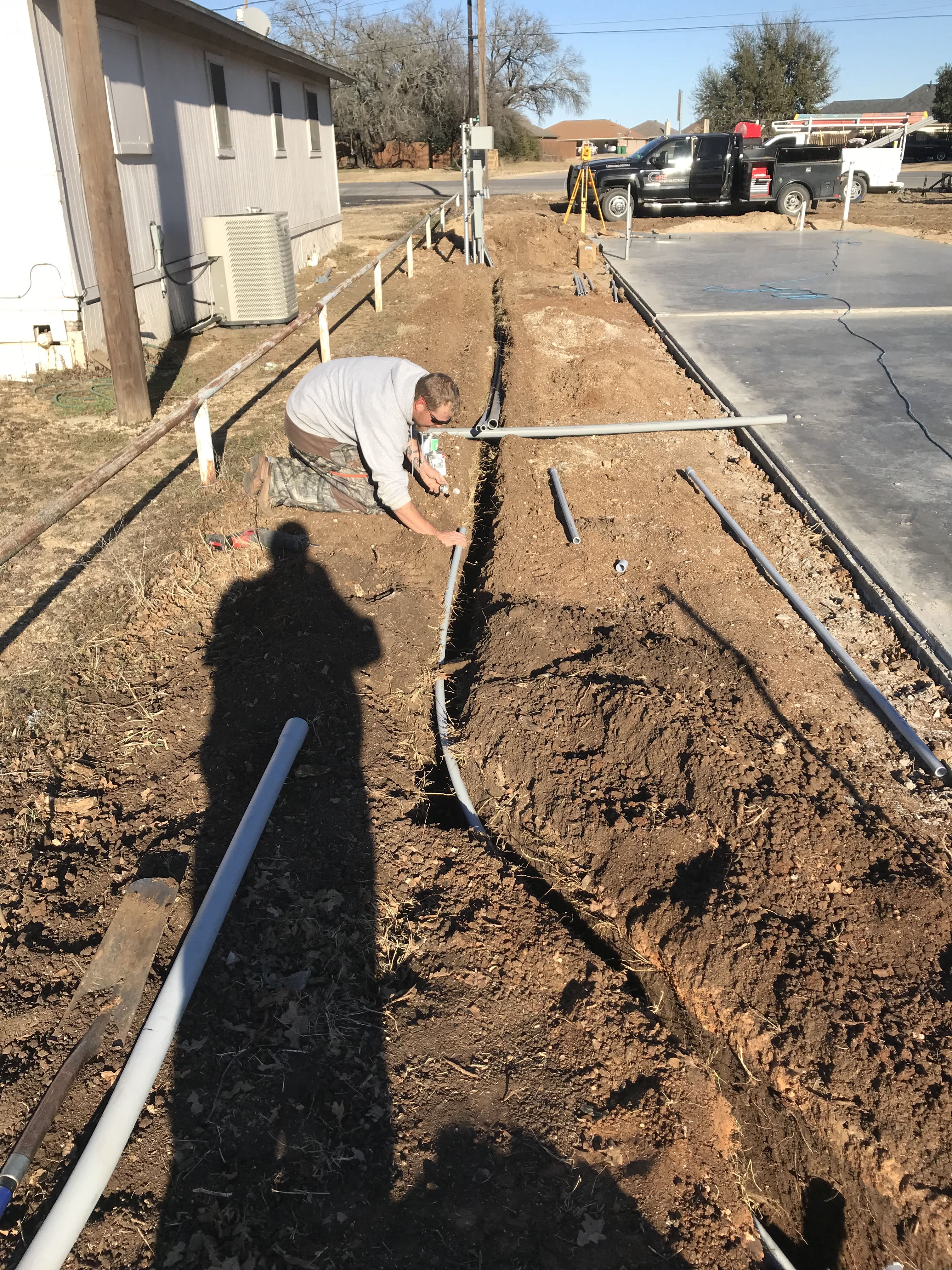 Underground electrical conduit trenching at a new construction site near Stephenville, TX.