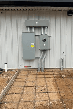 New electrical meter and panel installation on the exterior of a building near Stephenville, TX.